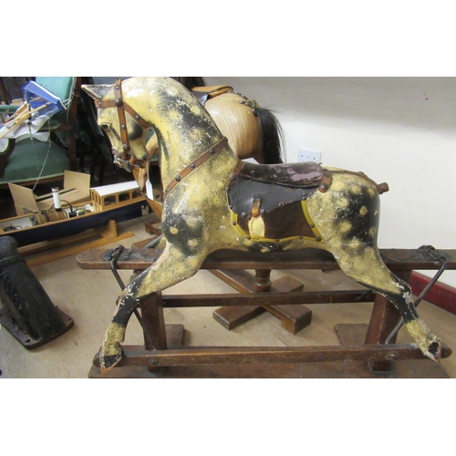 285 - An antique rocking horse, or carved wood construction, amber glass eyes, dappled grey paint, velvet ... 