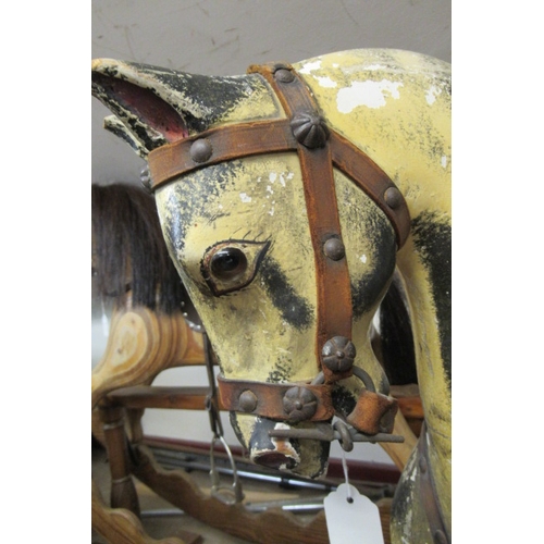 285 - An antique rocking horse, or carved wood construction, amber glass eyes, dappled grey paint, velvet ... 