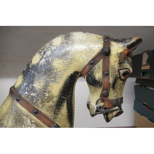 285 - An antique rocking horse, or carved wood construction, amber glass eyes, dappled grey paint, velvet ... 