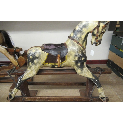 285 - An antique rocking horse, or carved wood construction, amber glass eyes, dappled grey paint, velvet ... 