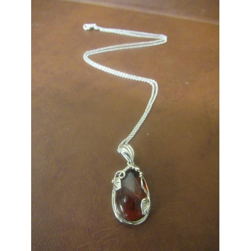 211 - SILVER AND AMBER PENDANT ON CHAIN