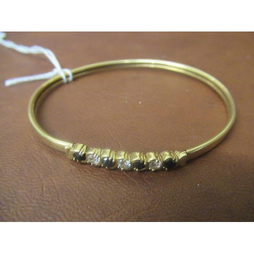 213 - 9CT GOLD AND SAPPHIRE BANGLE