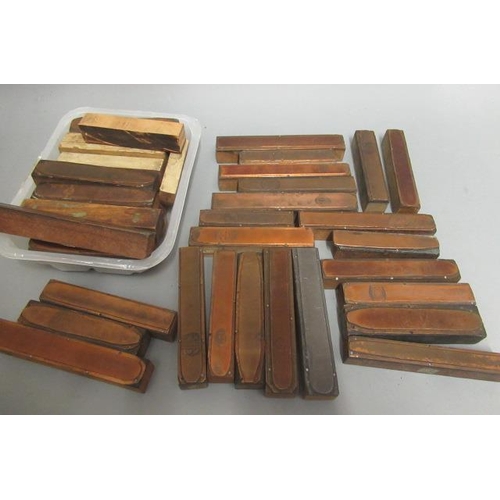 100 - Approximately 40 Copper cigar printing blocks, mounted on hardwood