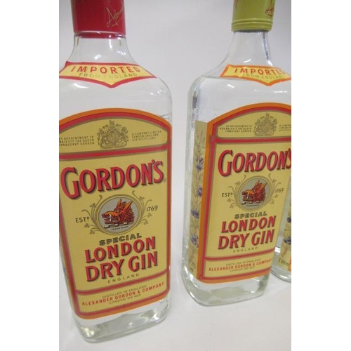 89 - 4 bottles of Gordons gin comprising 1 vintage 26.6fl.oz. snap cap top bottle, 2 1litre 47.3% vol. an... 