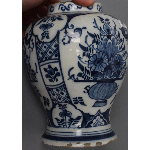 11 - A DUTCH DELFT VASE, late 18th century, of inverted baluster form painted in blue with three panels e... 