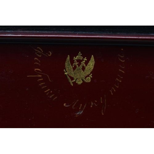 125 - A RUSSIAN LACQUERED BOX, 19th century, Lukutin factory, of plain rounded oblong form, the cover pain... 