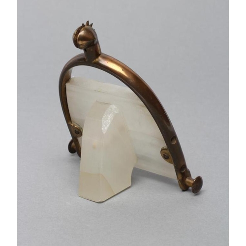 148 - AN ART DECO WHITE ONYX PERPETUAL CALENDAR, the strut back supported on a spurred stirrup stand stamp... 