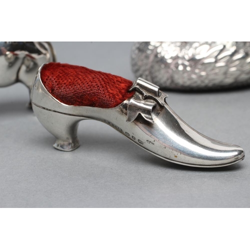 169 - THREE NOVELTY SILVER PIN CUSHIONS comprising a shoe with bow and buckle on a Louis heel, Birmingham ... 