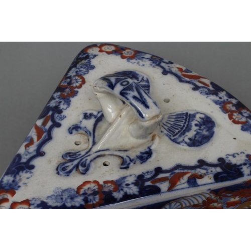 17 - A VICTORIAN STAFFORDSHIRE POTTERY CHEESE WEDGE AND STAND printed in underglaze blue and overpainted ... 