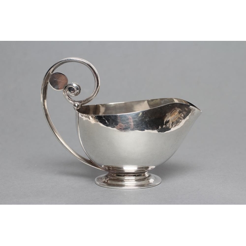 264 - JOHAN ROHDE FOR GEORG JENSEN, a butter boat, stamped 925.S, Sterling 321B, the plain oval bowl with ... 