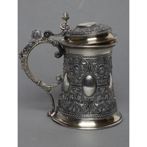 298 - A RUSSIAN TANKARD, post 1876, 84 standard, of swept cylindrical form chased with six vacant oval bos... 