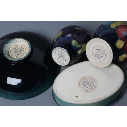 33 - A COLLECTION OF MOORCROFT CLEMATIS PATTERN POTTERY, mid 20th century, all tubelined and painted in c... 