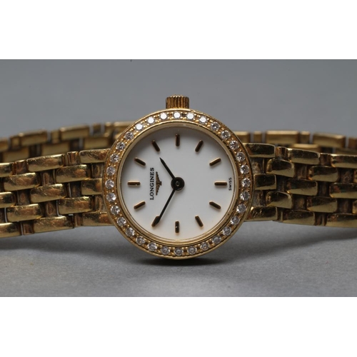 351 - A LADY'S LONGINES 18CT GOLD AND DIAMOND WRISTWATCH, the white dial with gilt batons, the quartz five... 