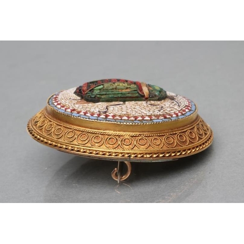 367 - A VICTORIAN MICRO-MOSAIC OVAL BROOCH, the coloured and lustre tesserae worked as a scarab on a white... 