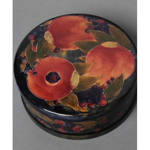 37 - A MOORCROFT POTTERY POMEGRANATE PATTERN LARGE BOX AND COVER, early 20th century, of plain cylindrica... 