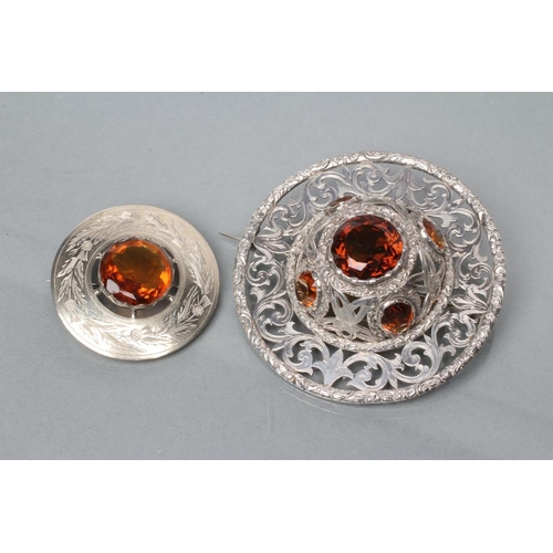 371 - A LARGE SCOTTISH PLAID BROOCH of circular form, pierced and engraved with scrolling foliage, the hig... 