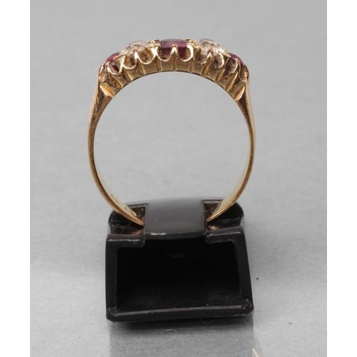 373 - A FIVE STONE RUBY AND DIAMOND RING, the central facet cut ruby flanked by two old cut diamonds and t... 