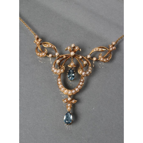 377 - AN EDWARDIAN NECKLACE, the open seed pearl set cartouche pendant with two facet tear cut aquamarines... 