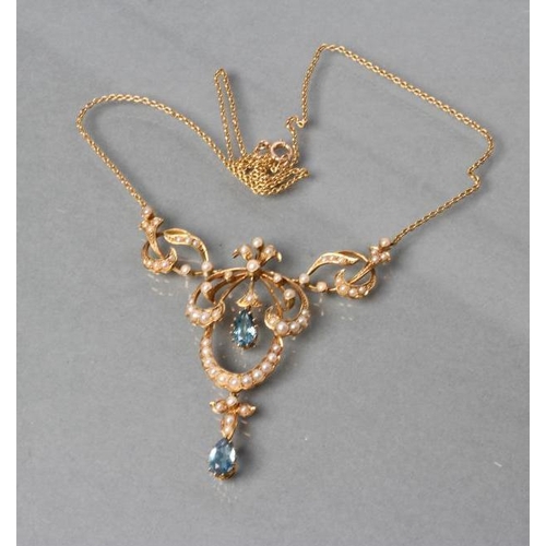 377 - AN EDWARDIAN NECKLACE, the open seed pearl set cartouche pendant with two facet tear cut aquamarines... 