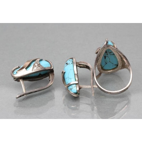 382 - A TURQUOISE MATRIX RING, the tear polished stone asymmetrically set in unmarked white metal with thr... 