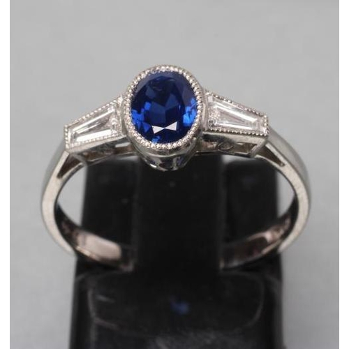 395 - A CEYLON SAPPHIRE AND DIAMOND RING, the oval facet cut sapphire of 1.26cts collet set to angular sho... 