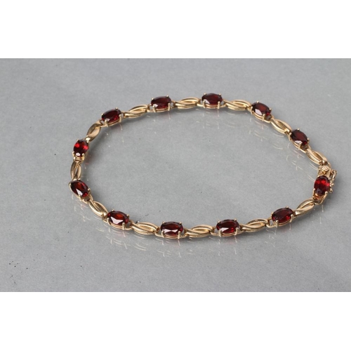 397 - A GARNET BRACELET, the twelve oval facet cut stones claw set to a plain chain, stamped 375 (Est. plu... 