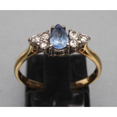 401 - A THREE STONE SAPPHIRE AND DIAMOND RING, the central oval facet cut stone claw set and flanked by tw... 