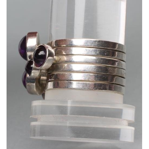 402 - A WENDY RAMSHAW SILVER AND AMETHYST STACKING RING, the six plain rings each set with a graduated clo... 