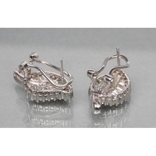 403 - A PAIR OF DIAMOND FRENCH CLIP EARRINGS, the leaf shaped panels set with baguette and brilliant cut s... 