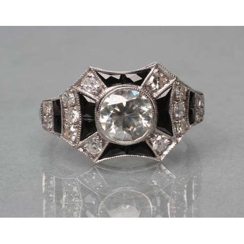 406 - AN ART DECO DIAMOND AND ONYX COCKTAIL RING, the old brilliant cut stone of approximately 1ct, open b... 