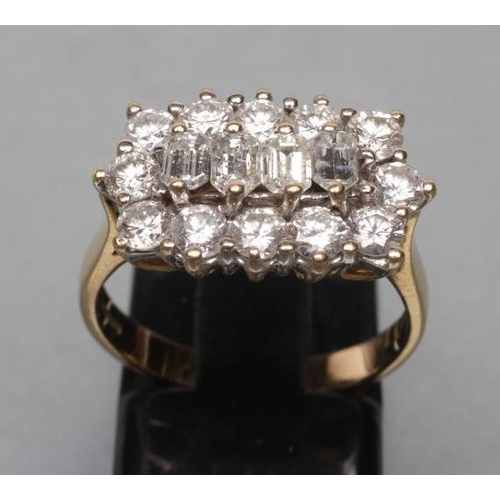 407 - A DIAMOND DRESS RING, the four baguette cut central stones point set to a border of twelve brilliant... 