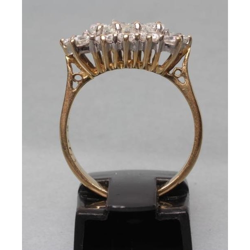 407 - A DIAMOND DRESS RING, the four baguette cut central stones point set to a border of twelve brilliant... 