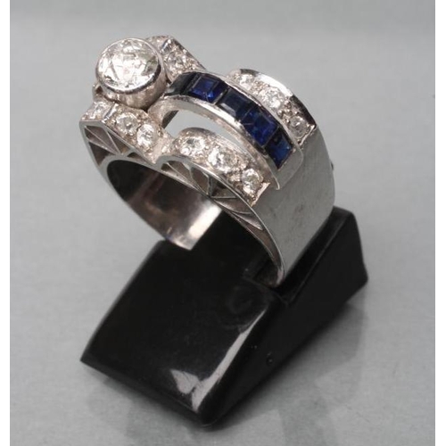 414 - AN ART DECO SAPPHIRE AND DIAMOND COCKTAIL RING, the oblong panel collet set with a brilliant cut dia... 