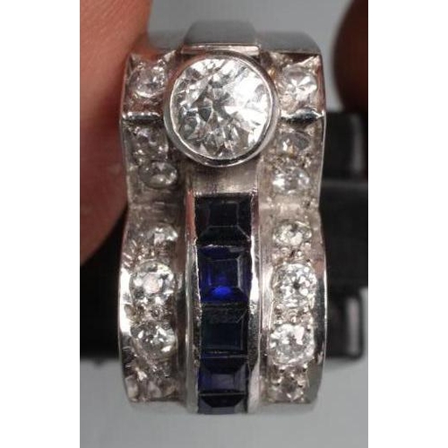 414 - AN ART DECO SAPPHIRE AND DIAMOND COCKTAIL RING, the oblong panel collet set with a brilliant cut dia... 