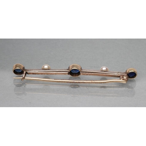 415 - A SAPPHIRE AND DIAMOND BAR BROOCH, open back collet set with three circular sapphires, rose cut diam... 