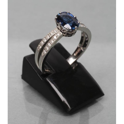 422 - A CEYLON SAPPHIRE AND DIAMOND DRESS RING, the oval facet cut sapphire of 1.06cts, claw set to open p... 