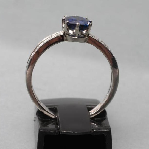 422 - A CEYLON SAPPHIRE AND DIAMOND DRESS RING, the oval facet cut sapphire of 1.06cts, claw set to open p... 