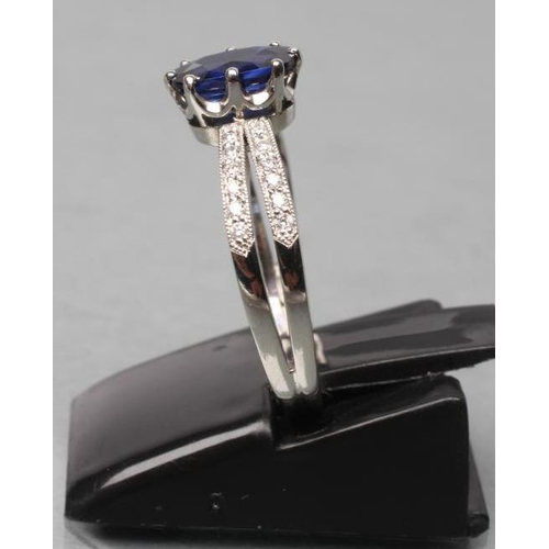 422 - A CEYLON SAPPHIRE AND DIAMOND DRESS RING, the oval facet cut sapphire of 1.06cts, claw set to open p... 