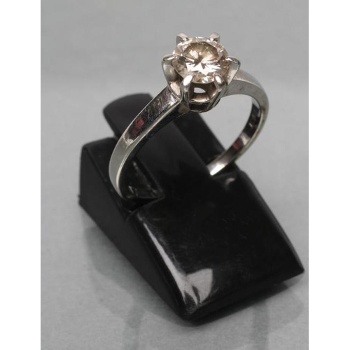 433 - A SOLITAIRE DIAMOND RING, the round brilliant of approximately 0.4cts claw set to a plain white shan... 