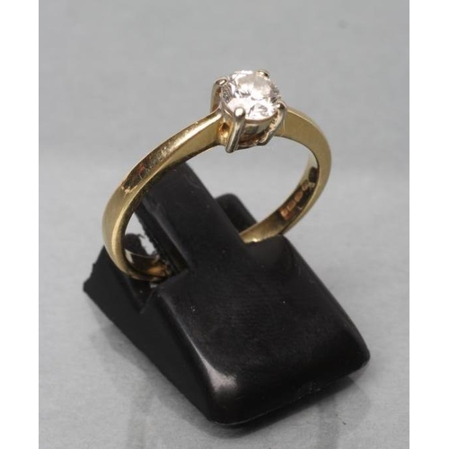 439 - A SOLITAIRE DIAMOND RING, the brilliant cut stone of approximately 0.6cts claw set to a plain 18ct g... 