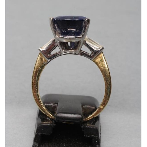 444 - A SAPPHIRE DRESS RING, the pear cut stone claw set to shoulders each set with a shaped baguette cut ... 