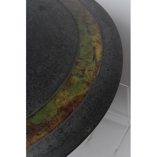 45 - ANDREW HILL (b.1964), A studio pottery shallow circular charger with a green and amber swirl glaze, ... 