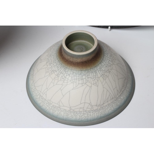 45 - ANDREW HILL (b.1964), A studio pottery shallow circular charger with a green and amber swirl glaze, ... 