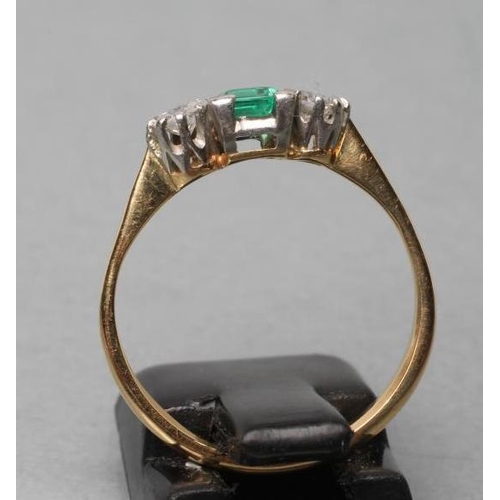 460 - AN EMERALD AND DIAMOND THREE STONE RING, centred by a square cut emerald claw set and flanked by two... 