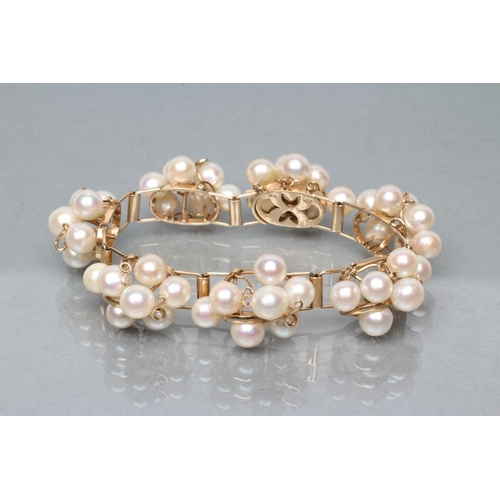 464 - A MODERN CULTURED PEARL BRACELET, the seven abstract set panels of seven pearls wired to a plain fra... 