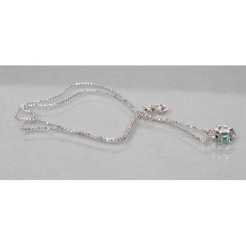 469 - AN EMERALD AND DIAMOND PENDANT, the oval facet cut emerald claw set to an open border of six small d... 