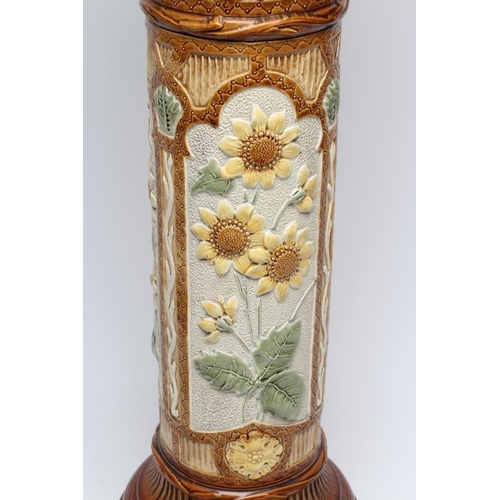 47 - A BURMANTOFTS FAIENCE JARDINIERE AND STAND, early 20th century, moulded in relief and painted in sha... 