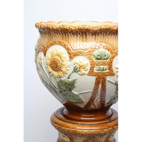 47 - A BURMANTOFTS FAIENCE JARDINIERE AND STAND, early 20th century, moulded in relief and painted in sha... 