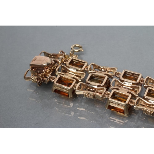 473 - A 9CT GOLD AND CITRINE BRACELET, the twenty four step cut citrines claw set to bow shaped links, wit... 