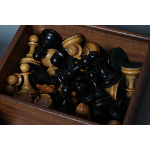 506 - TWO STAUNTON TYPE CHESS SETS, both in natural and ebonised box, kings 3 3/4